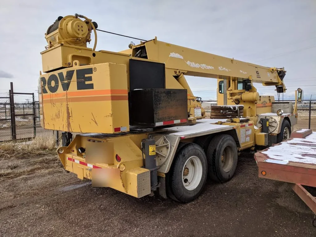 Rear three-quarter view of a Grove TMS522 truck crane showing the counterweight, boom and tandem-axle carrier